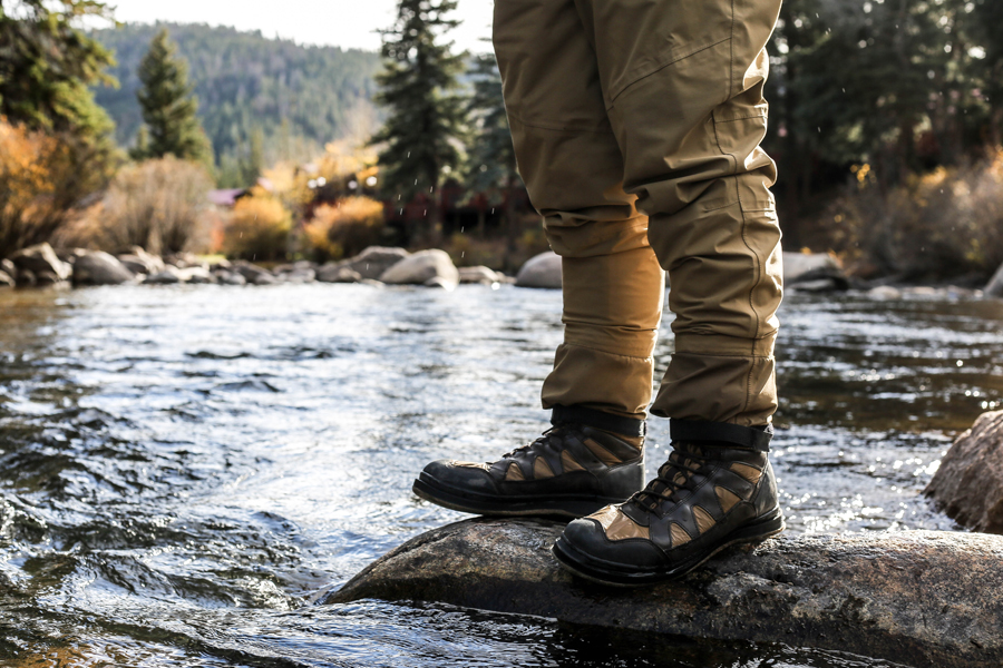 waterproof boots on top of a rock surrounded by water